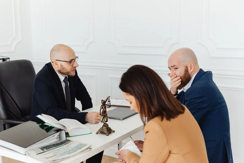 Client signing divorce decree paperwork with attorneyClient signing divorce decree paperwork with attorney