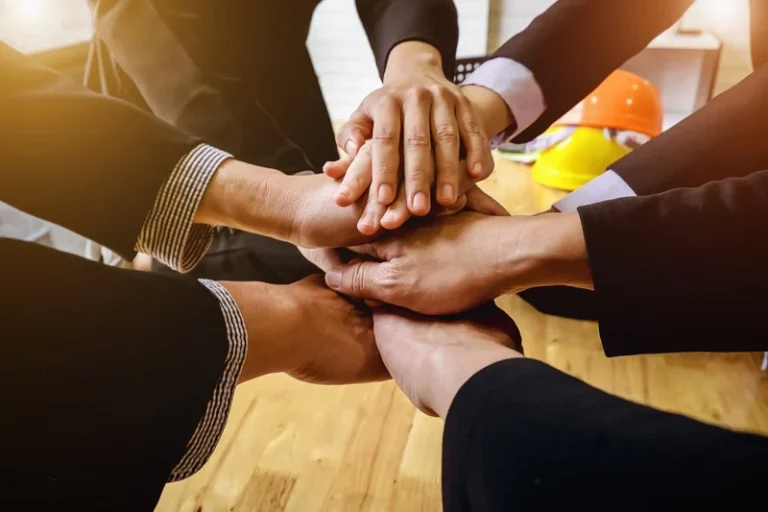 Hands stacking together symbolizing trust and teamwork